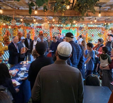 people gathered in a sukkah