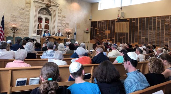 rabbi cantor leading service on the bimah