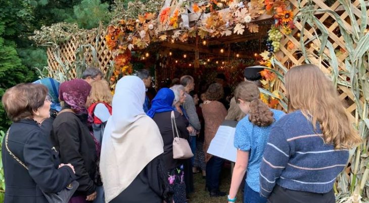 interfaith gathering in a sukkah